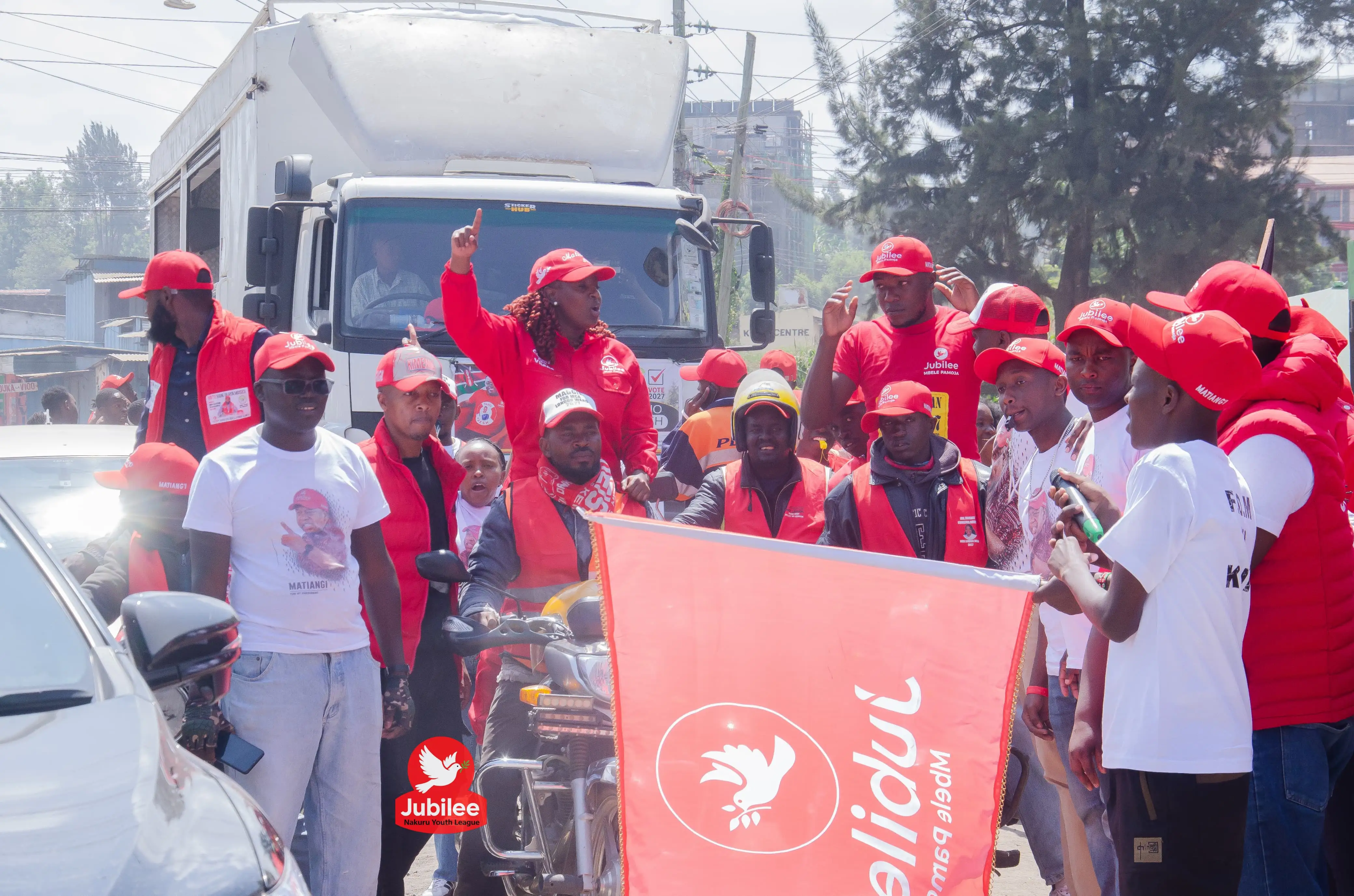 Supporters waving a Jubilee flag in a street convoy