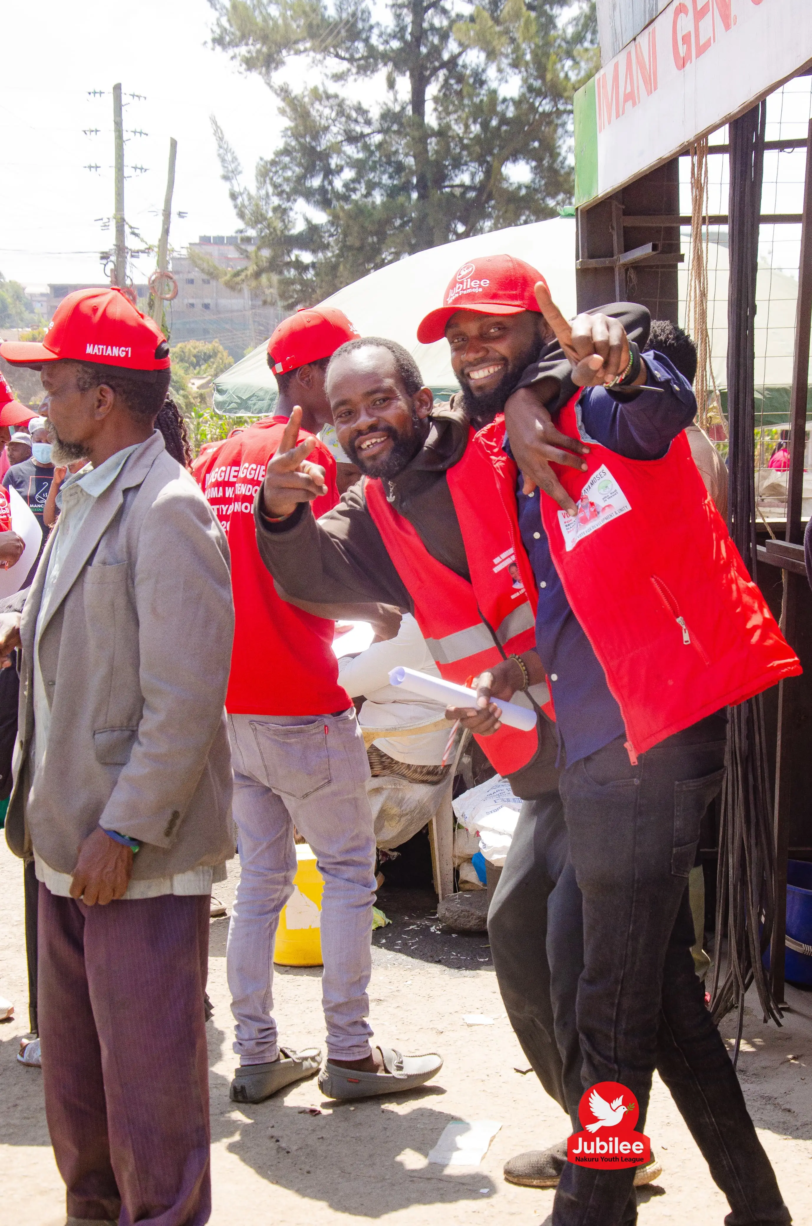 Smiling supporter in a red vest celebrating on the street