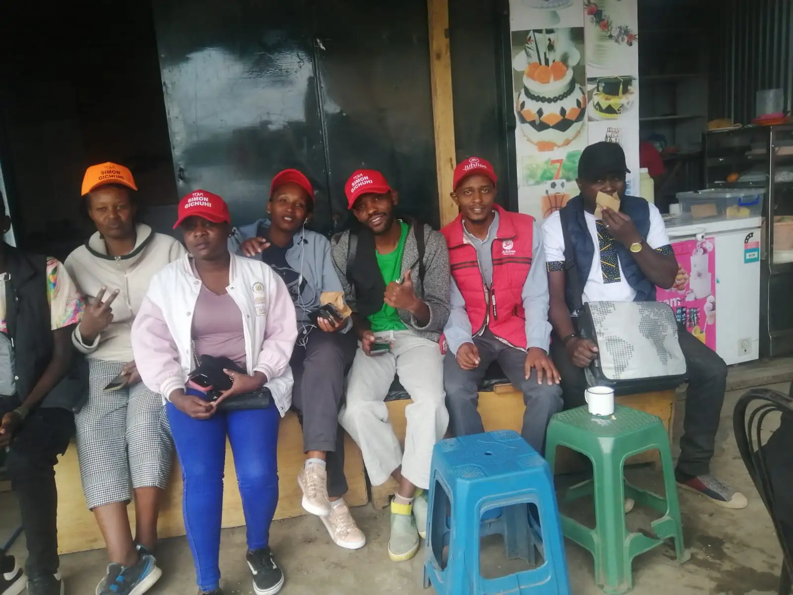 Group of young people sitting together in a shop front